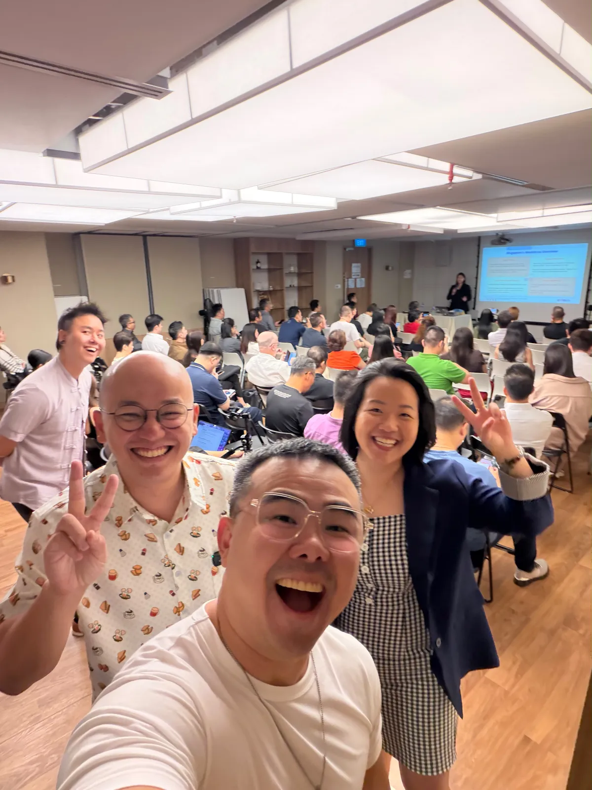 Haojun See and the Towkay Talks team taking a wefie, with the full room behind them